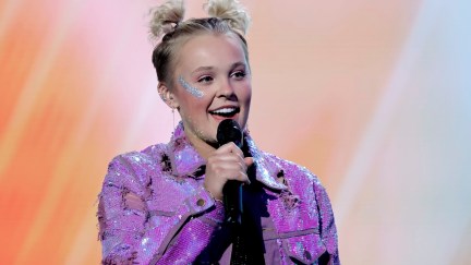 JoJo Siwa with a mic in her hand on stage