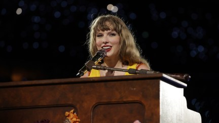 Taylor Swift sitting at a piano and smiling