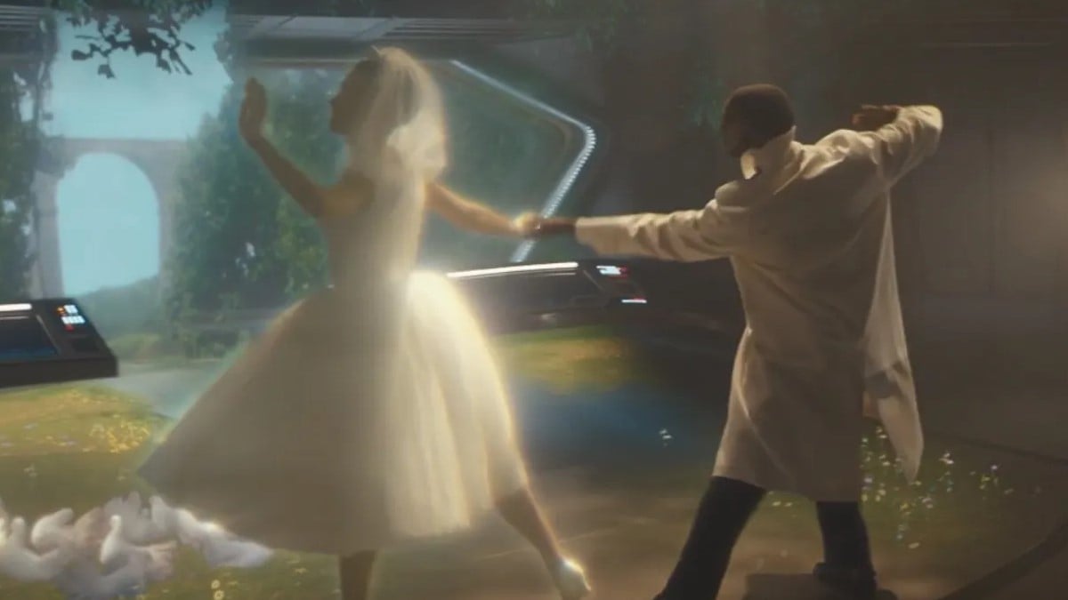 Image of Sash Striga as Zora's projected avatar and Aldis Hodge as Craft in the 'Star Trek: Short Treks' episode, "Calypso." They are mid-dance. She is a light-skinned Black woman in a 1950s-style wedding dress, and he is a dark-skinned Black man wearing a long, white tunic over black dress pants.