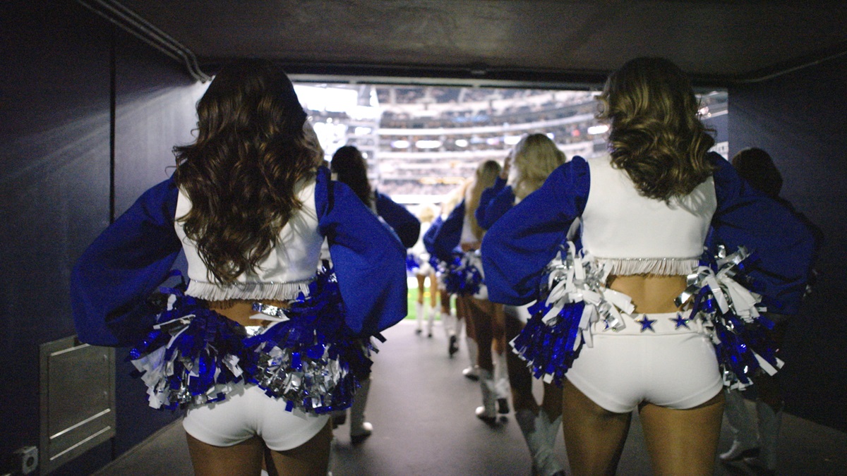 A view of the Dallas Cowboy Cheerleaders from behind as they enter the stadium