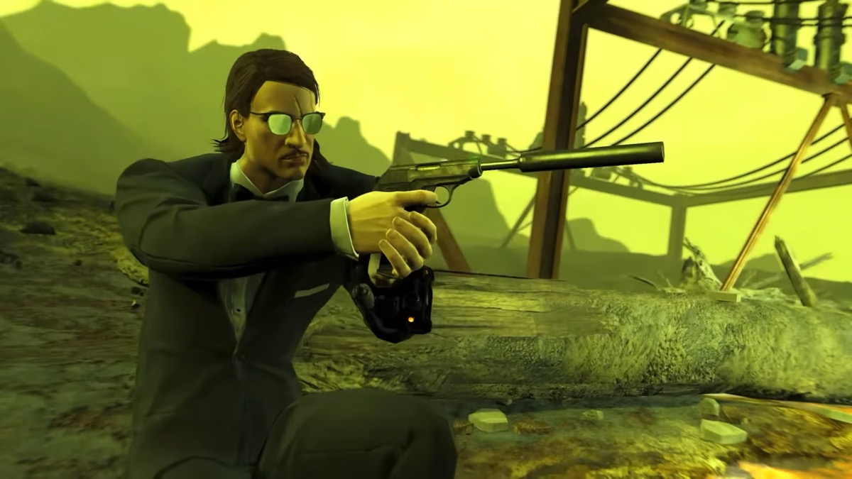 A man in a suit and tie crouches with a silenced pistol in "Fallout 4"