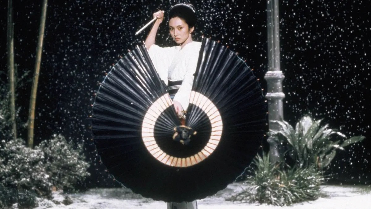A woman holds an umbrella and a tanto knife in "Lady Snowblood" 