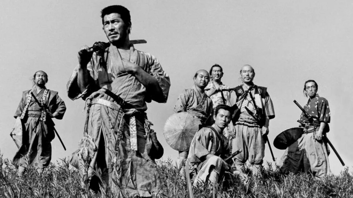 Seven samurai warriors stand on a hilltop looking over a field in "Seven Samurai"