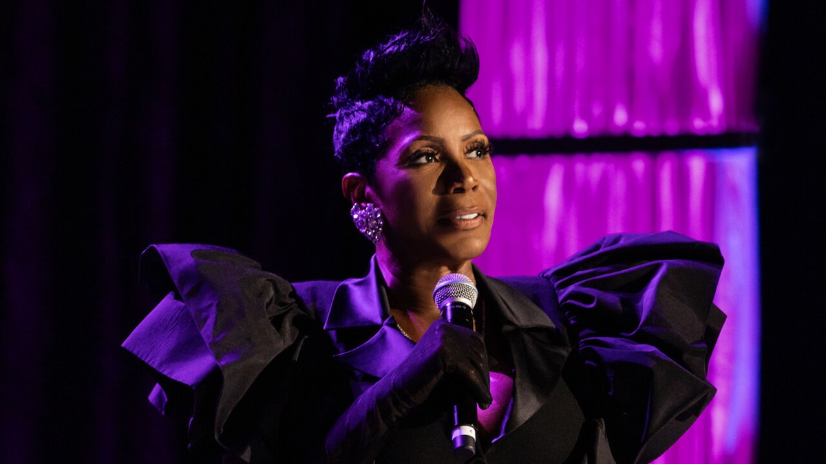 Sommore on stage against a purple backdrop