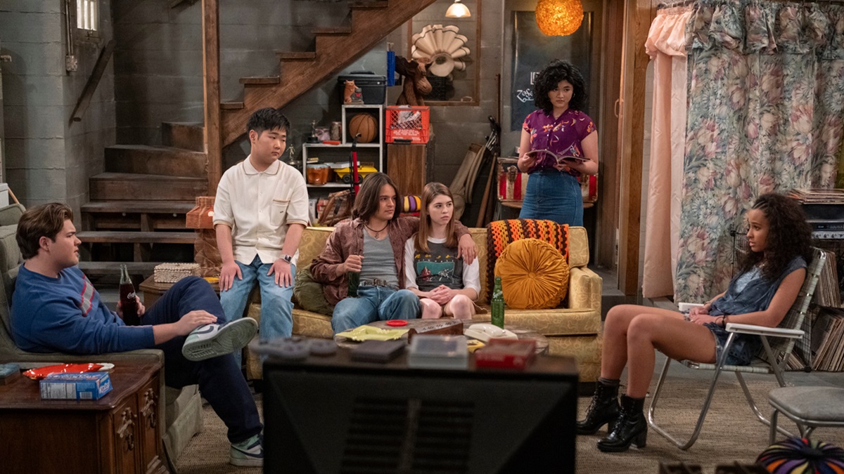 the cast of That 90s Show sitting in the iconic basement at the Forman's house.
