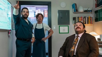 Carmine and others look up at a leak in the ceiling