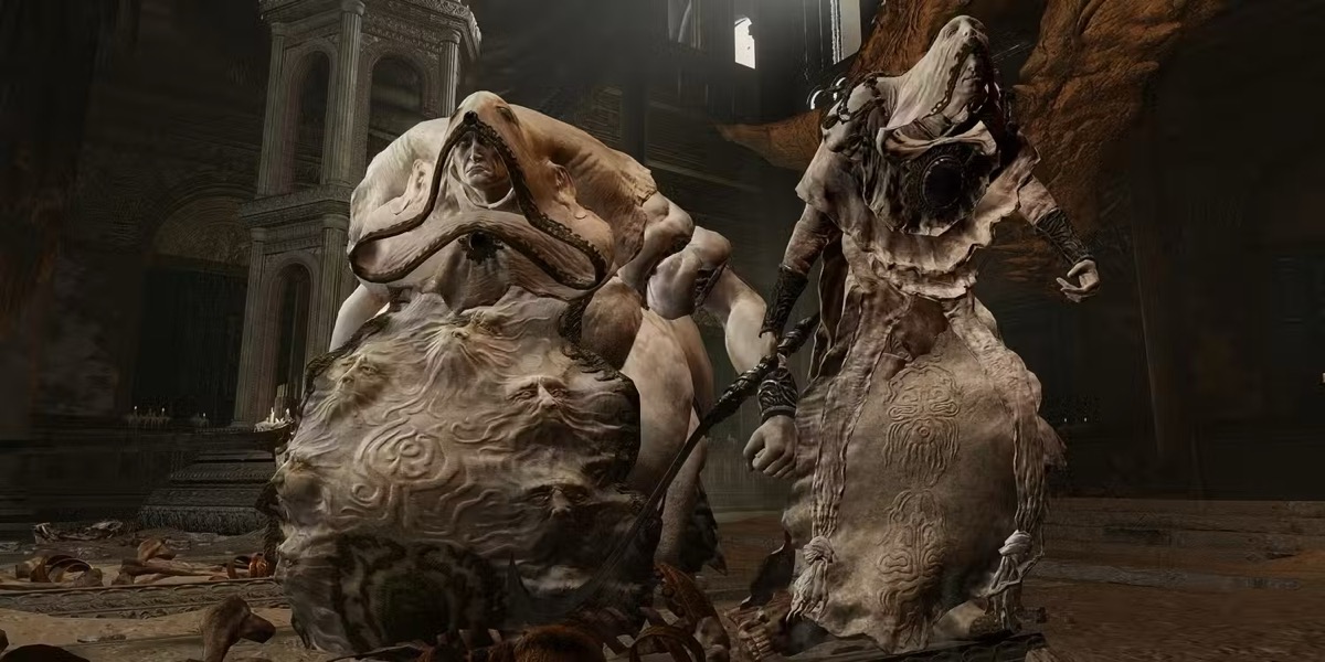 Two fleshy horrible humanoids stand menacingly in "Elden Ring"