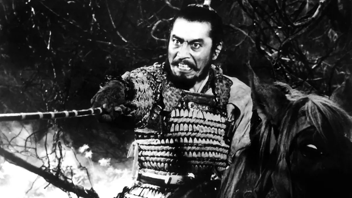 A samurai warrior grimaces and levels a sword at a foe in "Throne of Blood" 