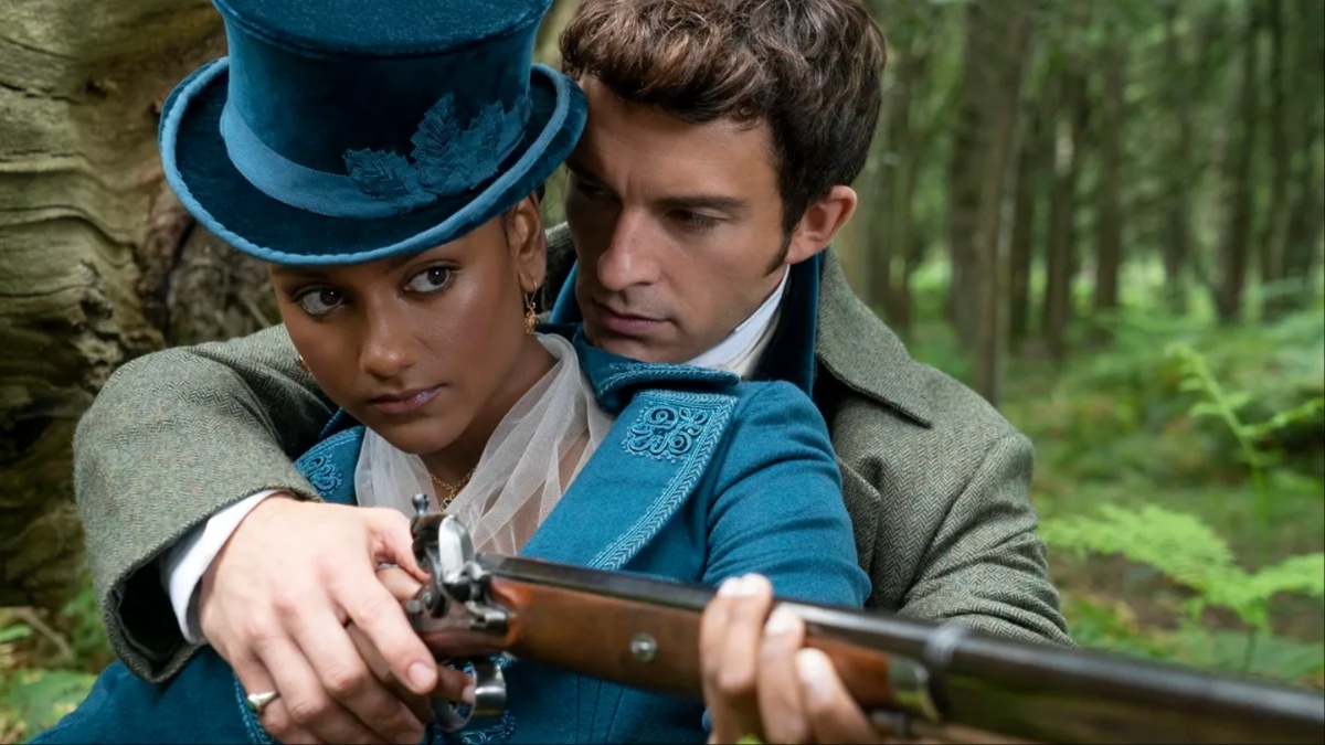 Anthony helps Kate aim her rifle in 'Bridgerton'.