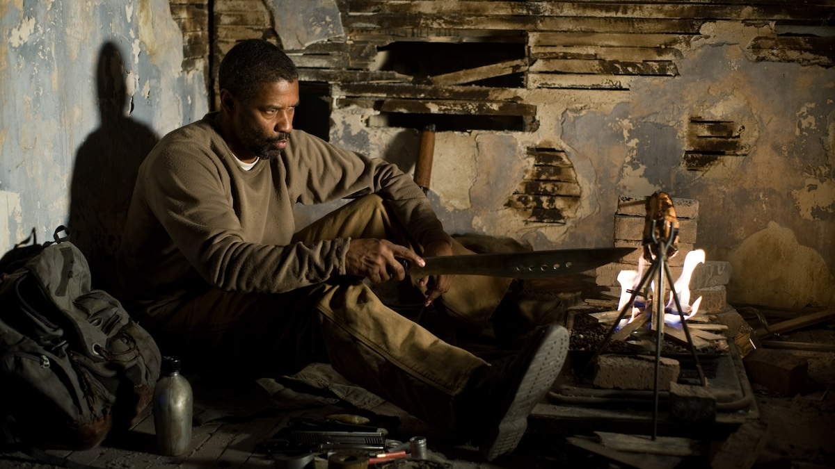 Denzel Washington sits in a rundown attic.