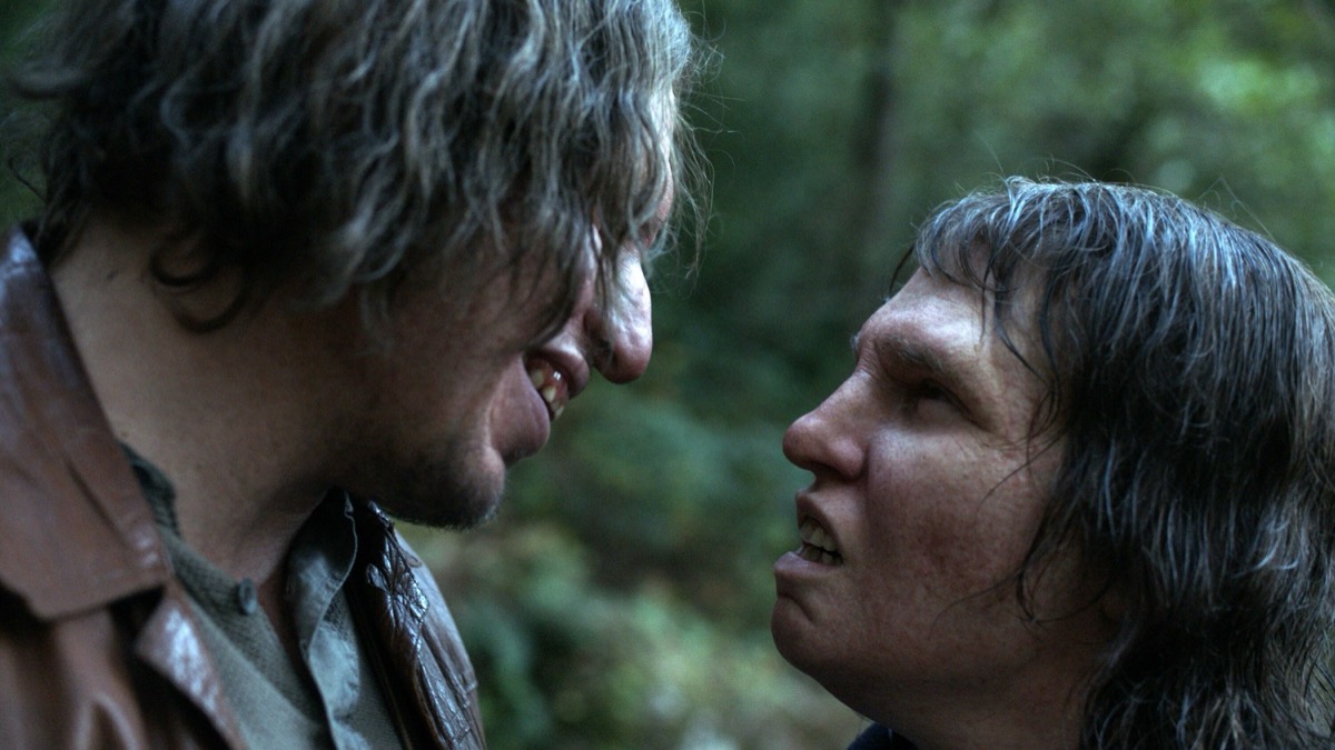 Two trolls in the woods look at each other lovingly in "Border"