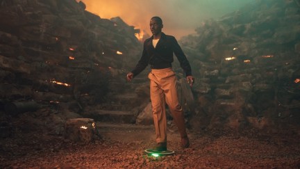 The Doctor standing on a roomba looking bomb in Doctor Who