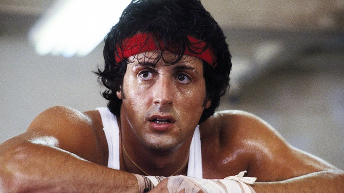 rocky balboa with long hair leaning on the ropes