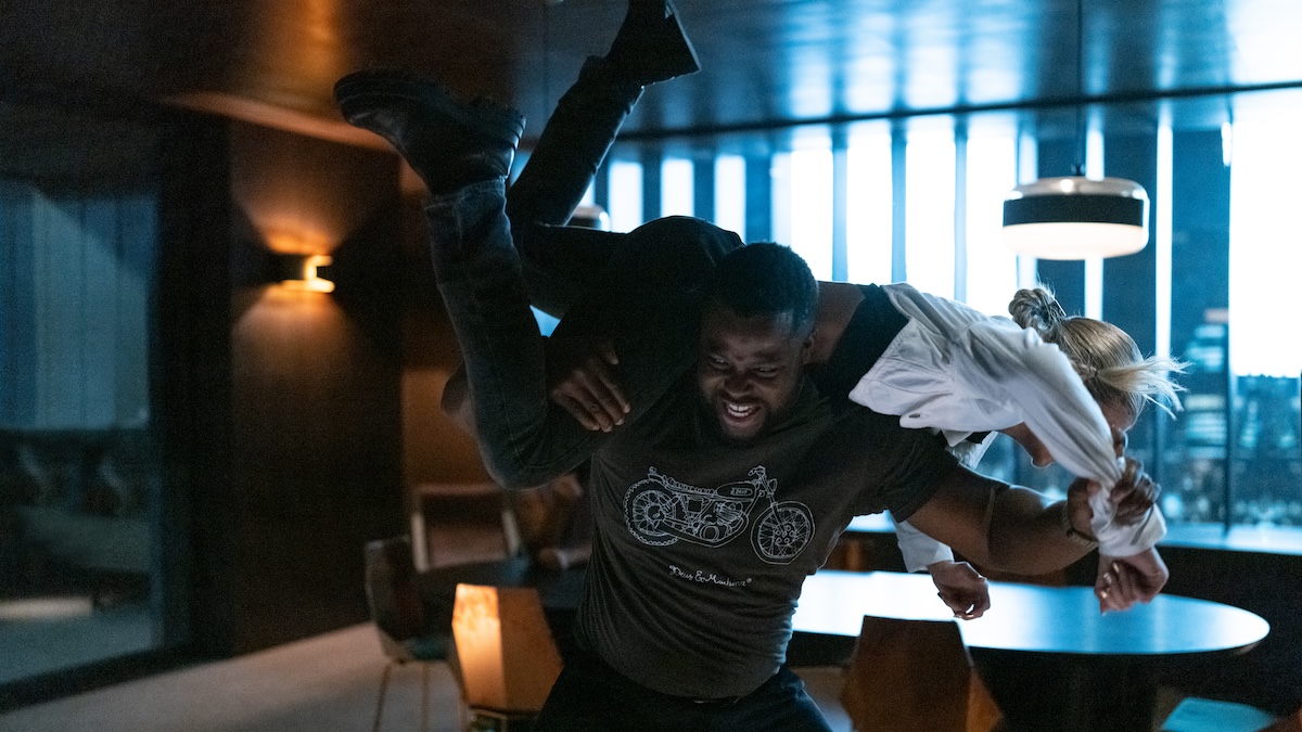 Winston Duke lifting someone over his head