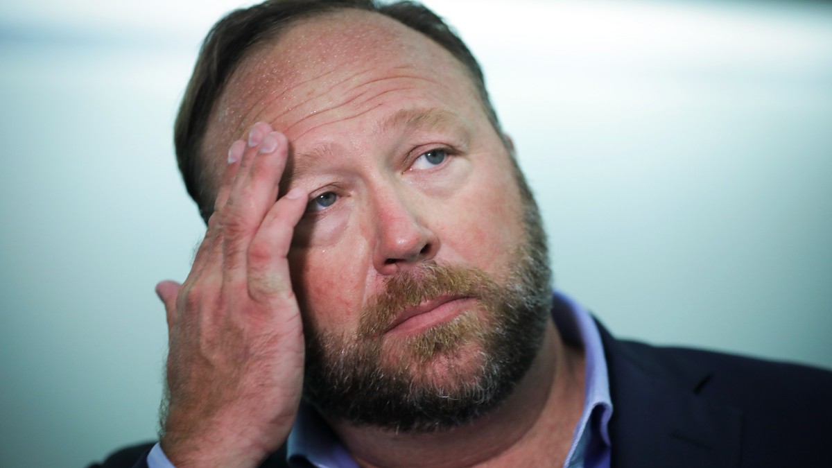 Alex Jones looking tired while talking to reporters in Washington, D.C.