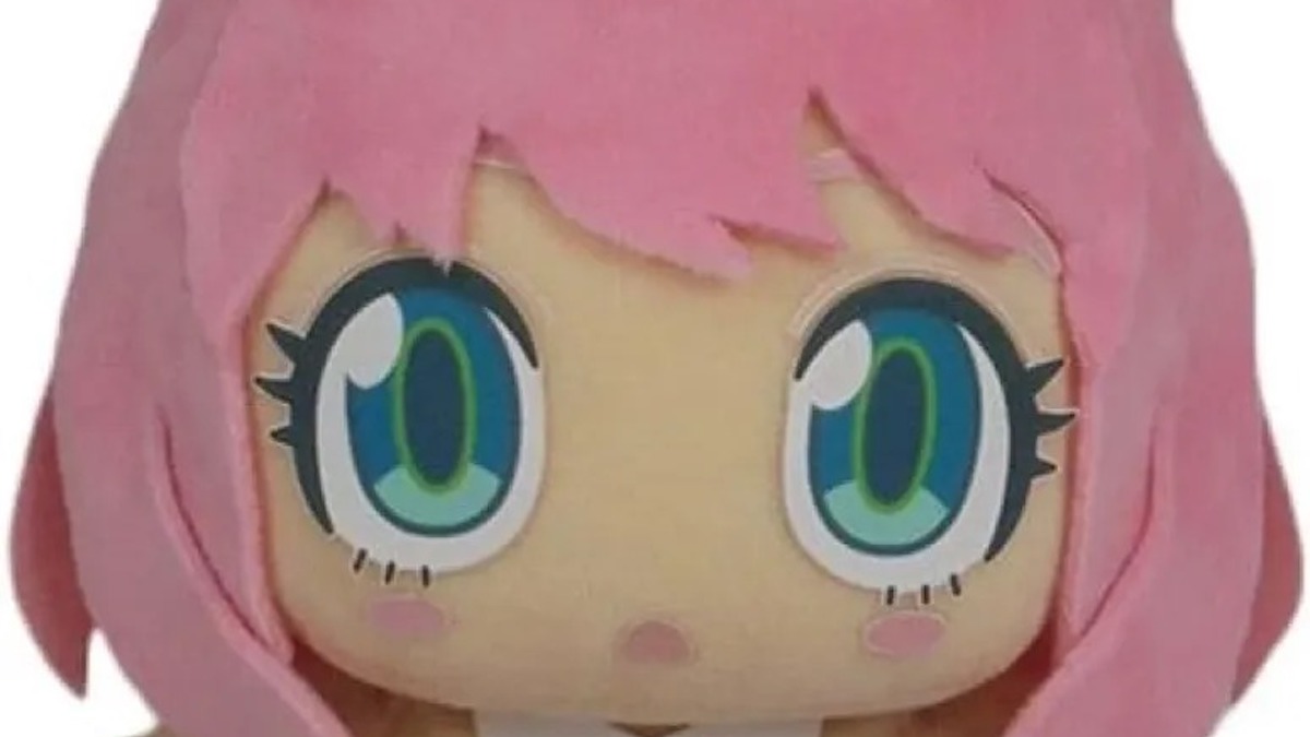 A closeup on the face of an Anya Forger plushie doll.