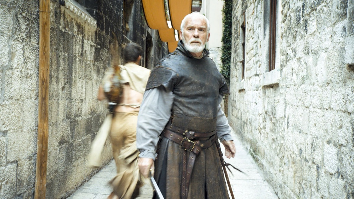 An old knight stands perplexed in a city street in "Game of Thrones" 