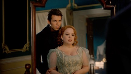 Luke Newton as Colin Bridgerton and Nicola Coughlan as Penelope Featherington embracing in front of a mirror in the Bridgerton season 3, part 2 trailer