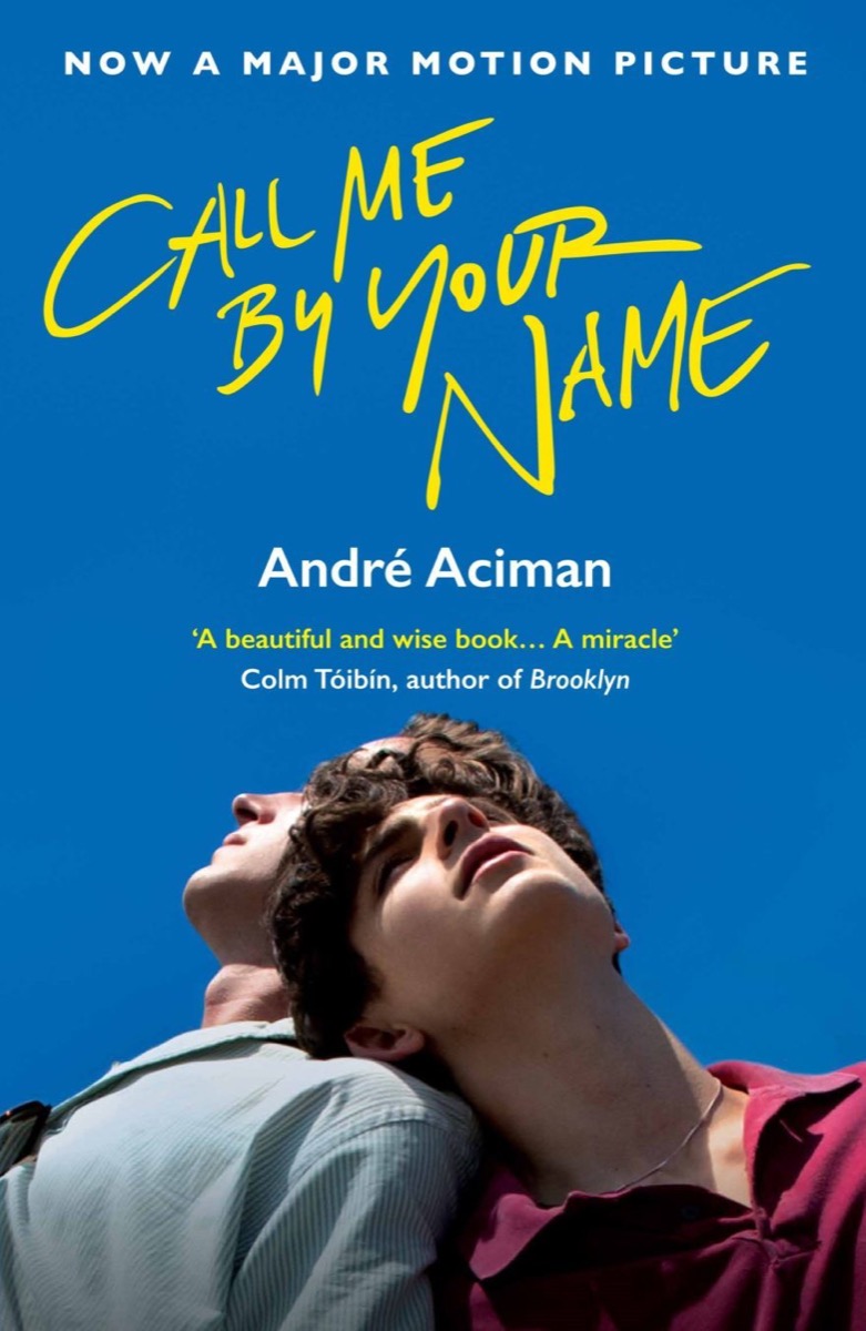 The cover art for "Call Me By Your Name" featuring two men leaning on each other
