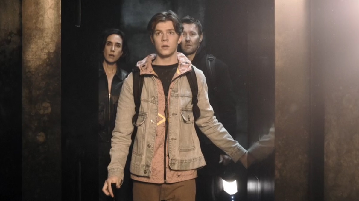 Charlie opens the door to a bright light while his parents stand behind him in the doorway