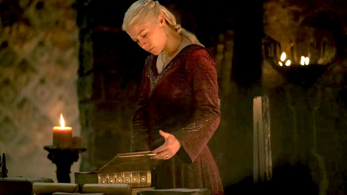 Emma D'Arcy as Rhaenyra Targaryen standing and reading a book in House of the Dragon season 2
