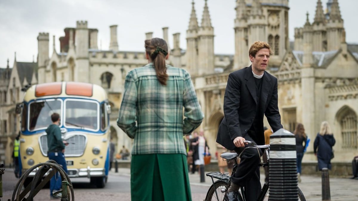 James Norton as Sidney Chambers riding his bike through the streets of Cambridge in Grantchester