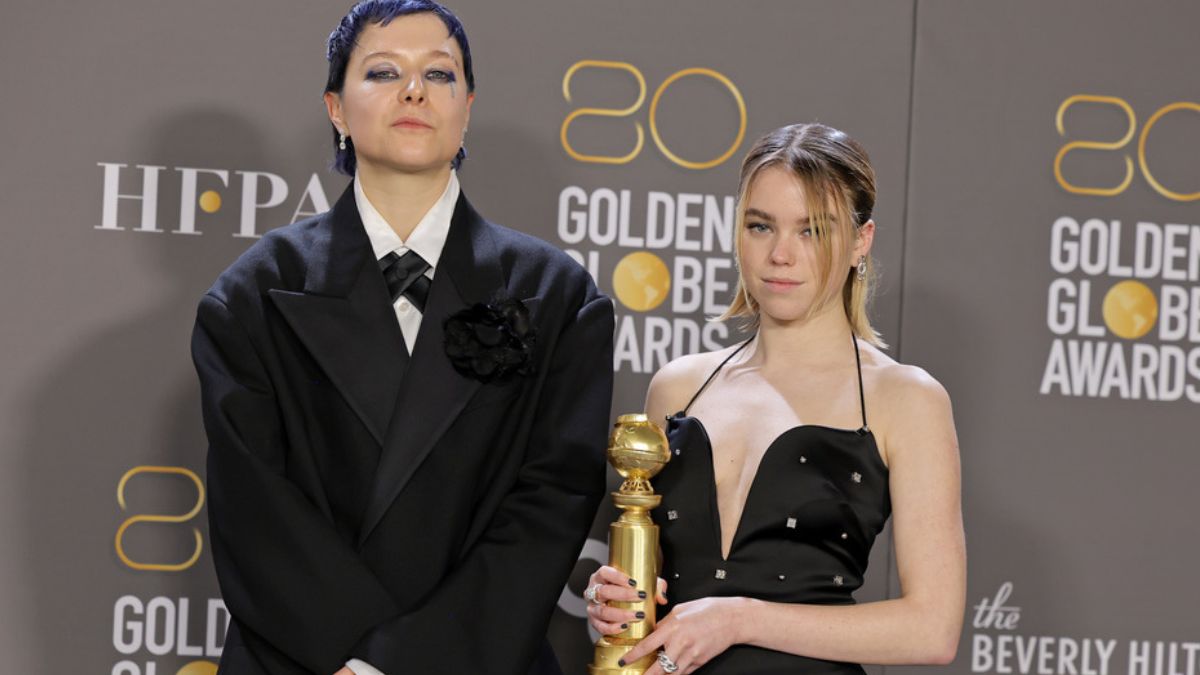 Emma D'Arcy and Milly Alcock posing with the Golden Globe won by House of the Dragon in 2023