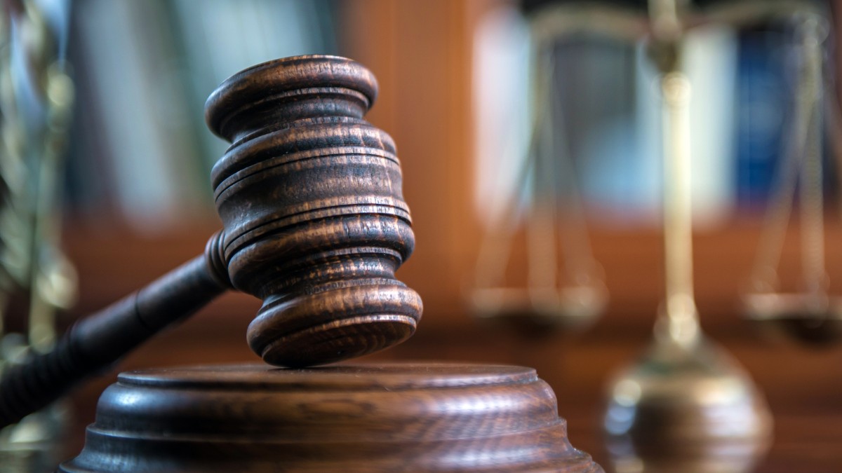 A judge's mallet inside a courtroom