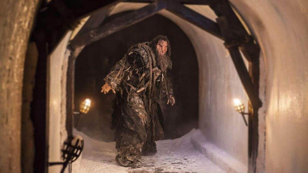 A giant stands in a torchlit tunnel in "Game of Thrones" 