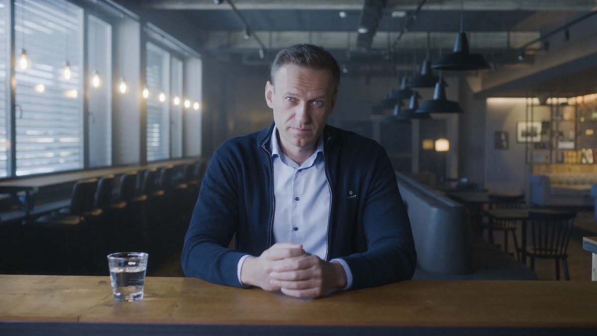 A man leans with hands folded on a bar in "Navalny" 