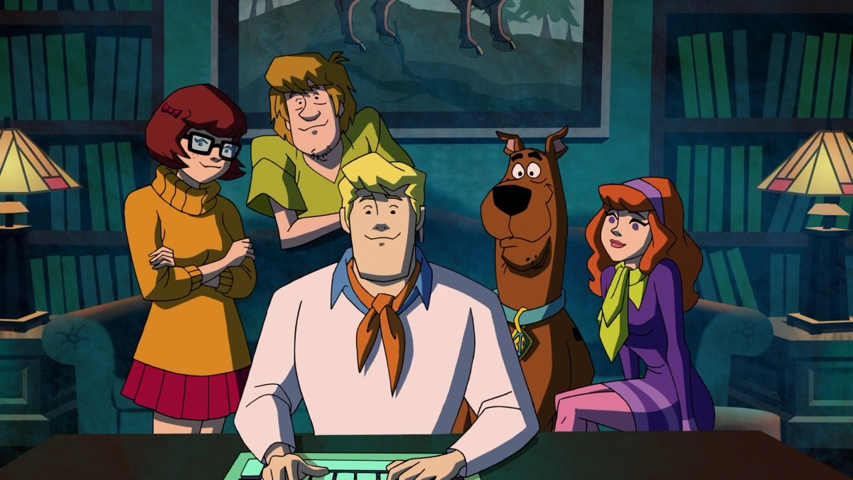 The Scooby Doo gang gathers around a computer screen in "Scooby Doo! Mysteries Incorportated" 