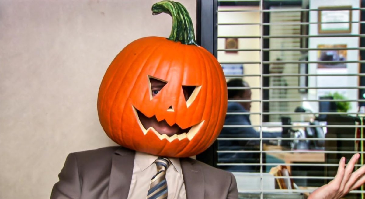 Dwight wearing a pumpkin on his head