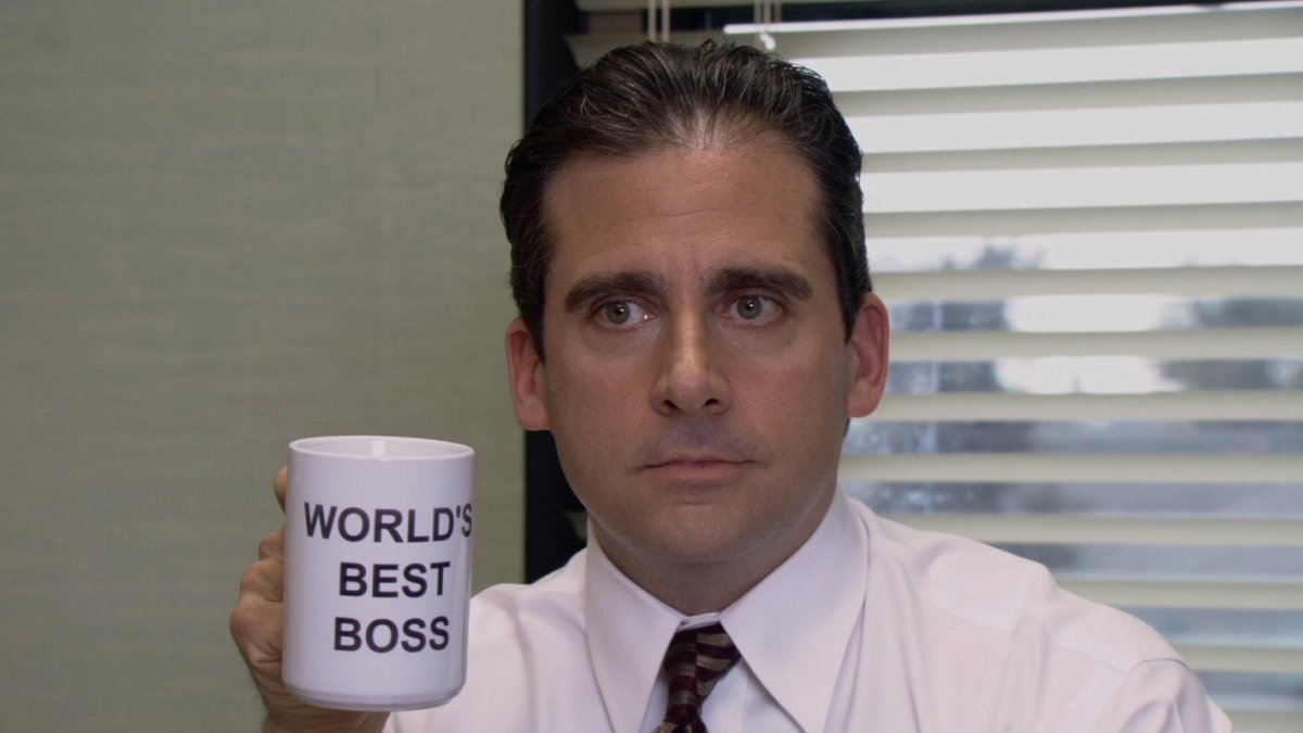 Michael Scott holding a 'World's Best Boss' mug