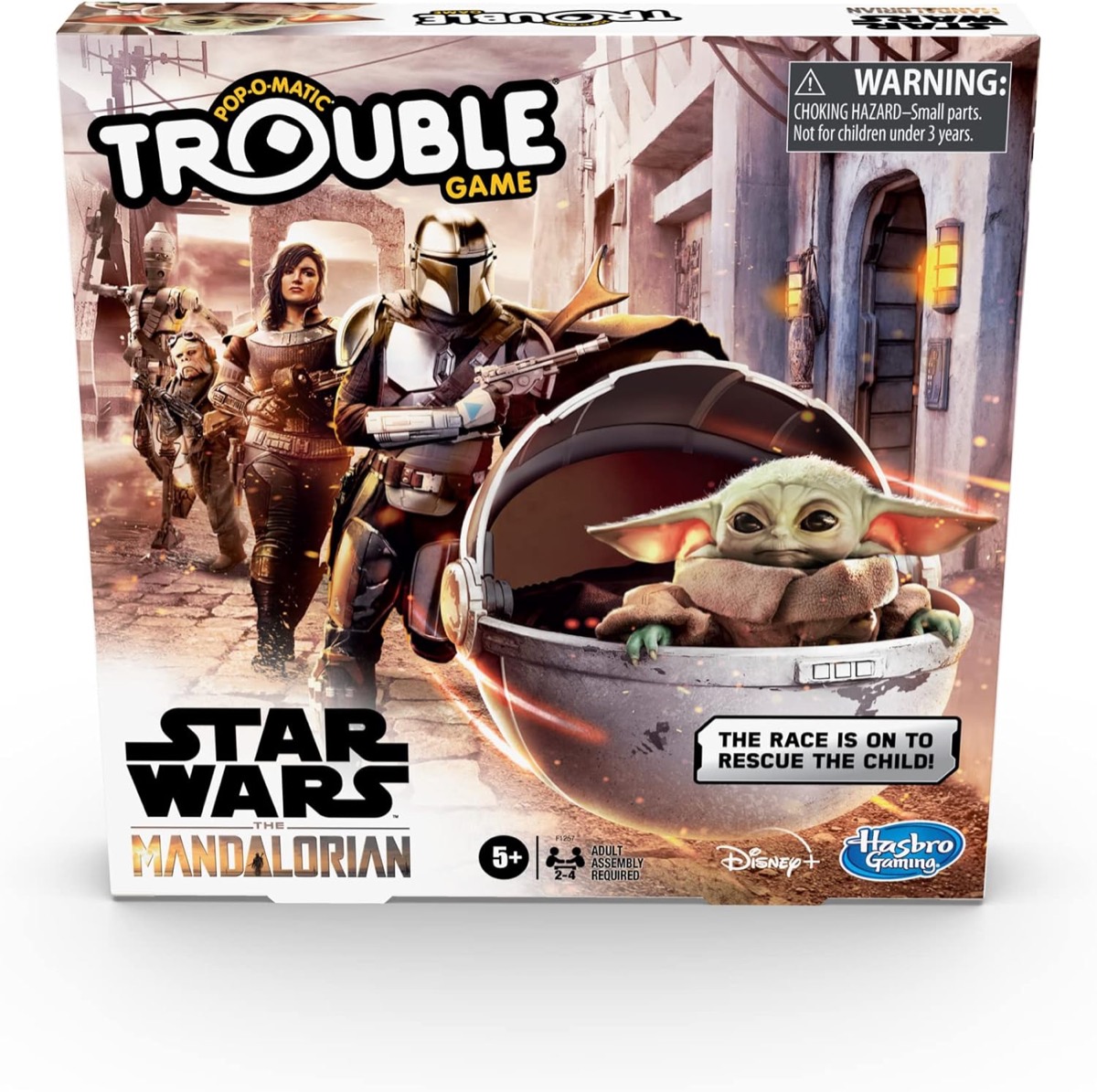 Box art for Trouble- Star Wars The Mandalorian Edition featuring The Child being chased by Mando and a comrade 