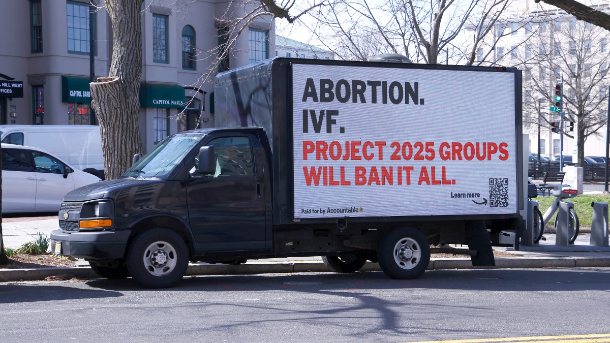 A truck with an poster for the Expose Project 2025 campaign