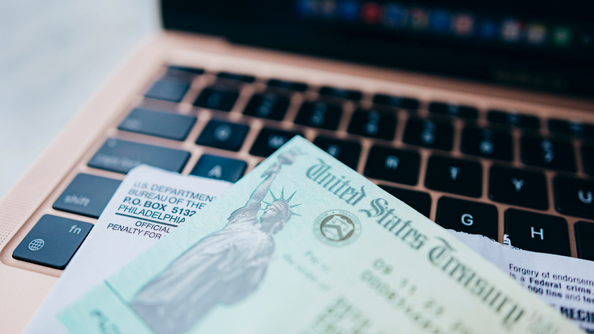 A US Treasury check laying on a laptop keyboard