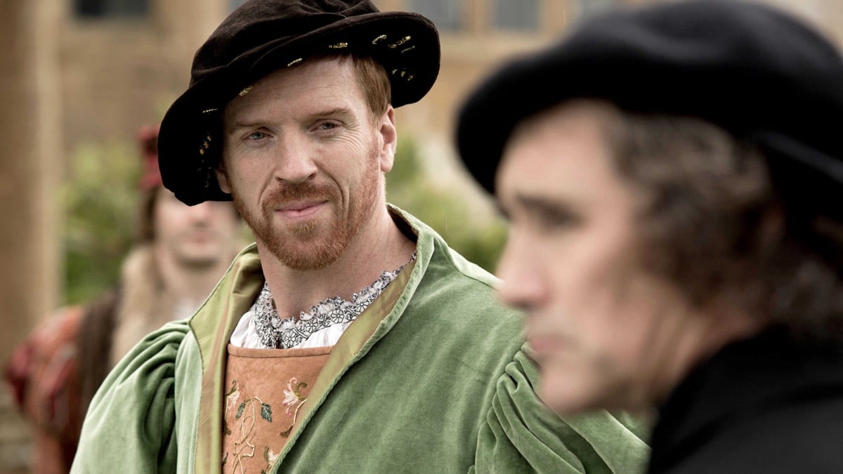 A nobleman gives a knowing look at another character in "Wolf Hall" 