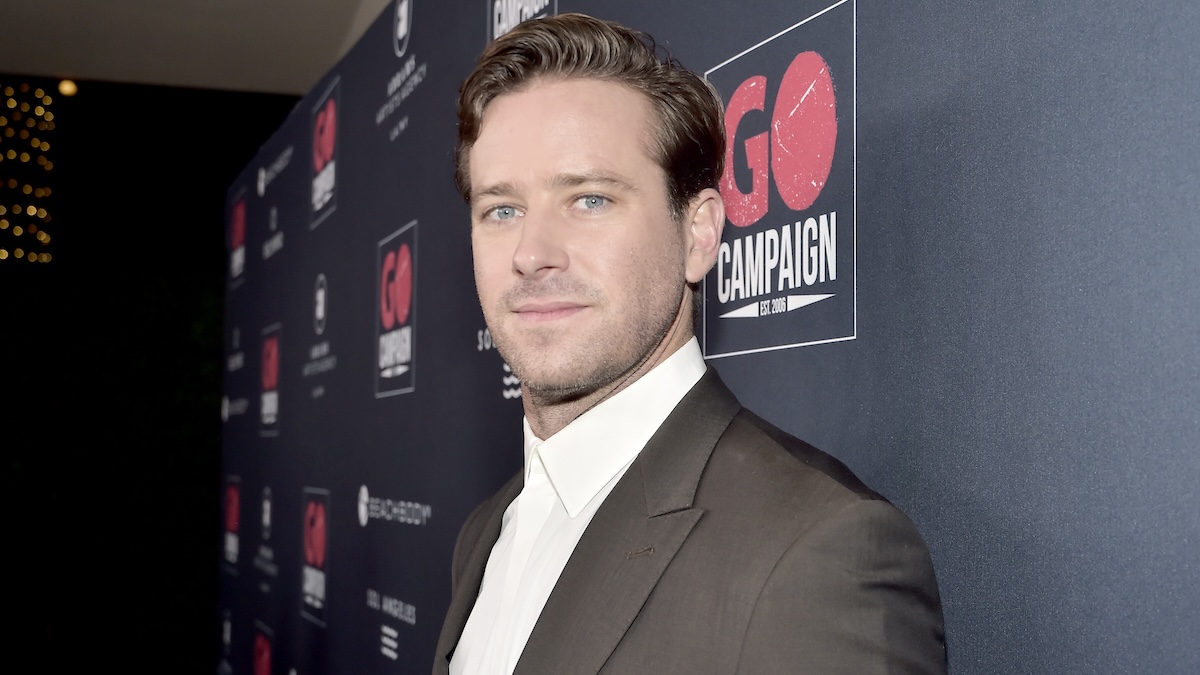 Armie Hammer looking at the camera on a red carpet