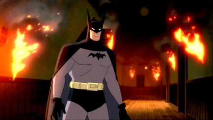 Batman is surrounded by flames in 'Batman: Caped Crusader'.