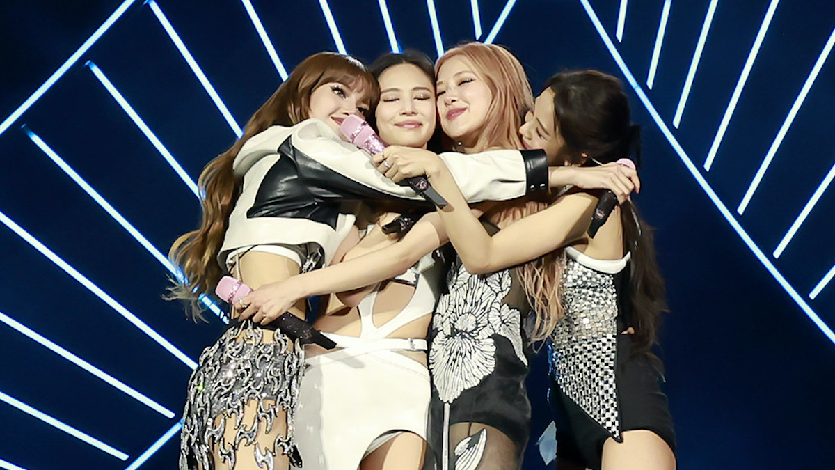 Blackpink in a group hug on stage