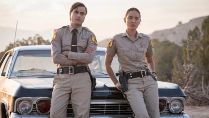 Characters from 'Dark Winds' pose in front of a car