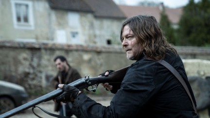 Norman Reedus holding a gun as Daryl Dixon