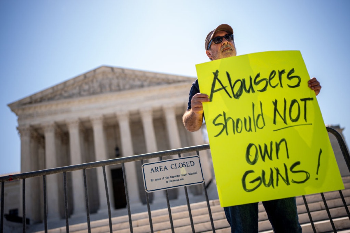A protester against domestic abusers owning guns, in front of the US Supreme Court.