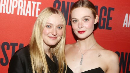 Elle and Dakota Fanning smile posing together on a red carpet.