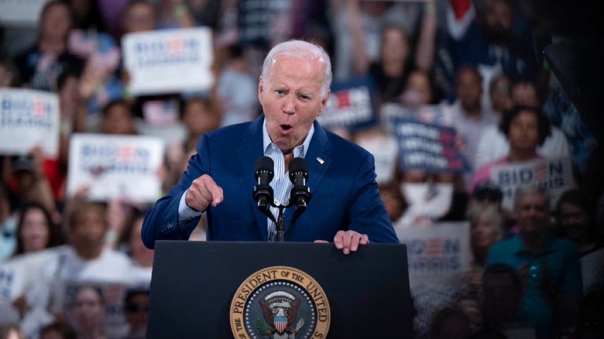 President Joe Biden speaking emphatically at a podium.