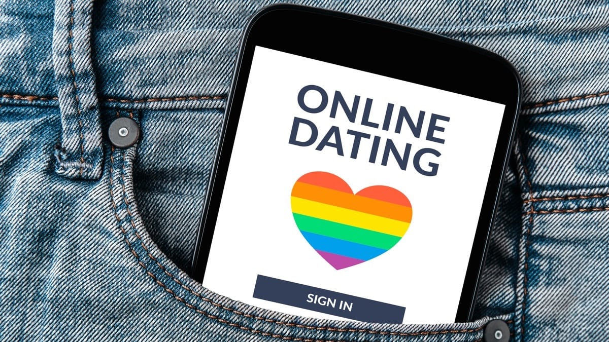 LGBT dating app concept on smartphone screen in jeans pocket.