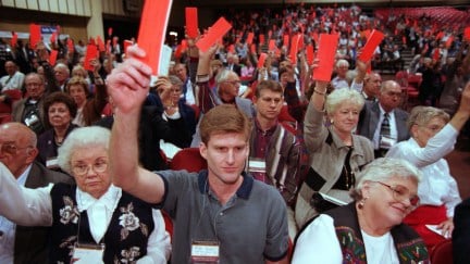 Voters raise orange ballots at a Southern Baptist Convention.