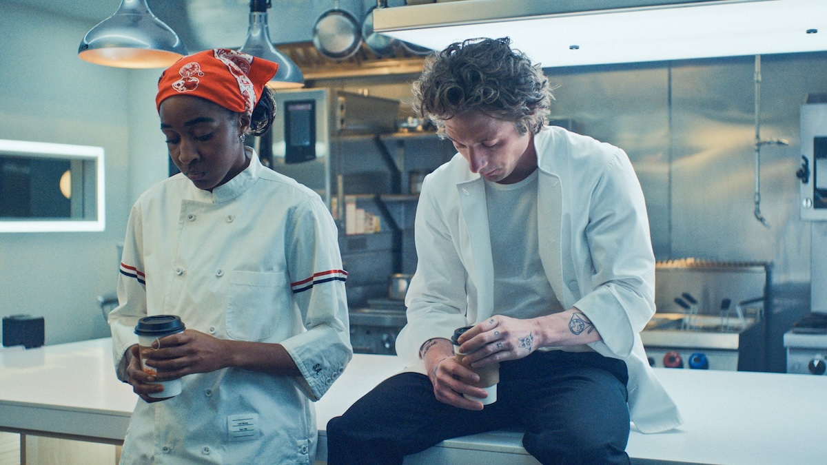 syd and carmy sitting together in the kitchen on the bear