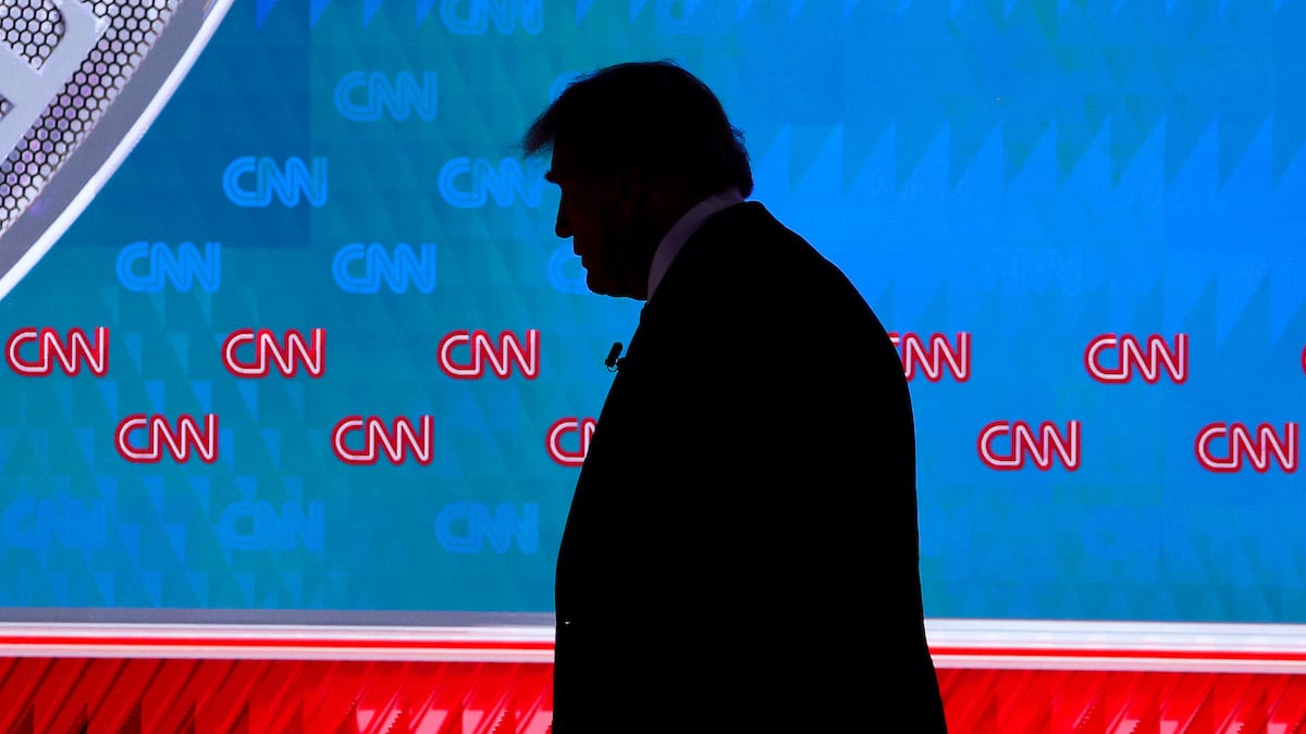 Donald Trump seen in silhouette leaving the debate stage