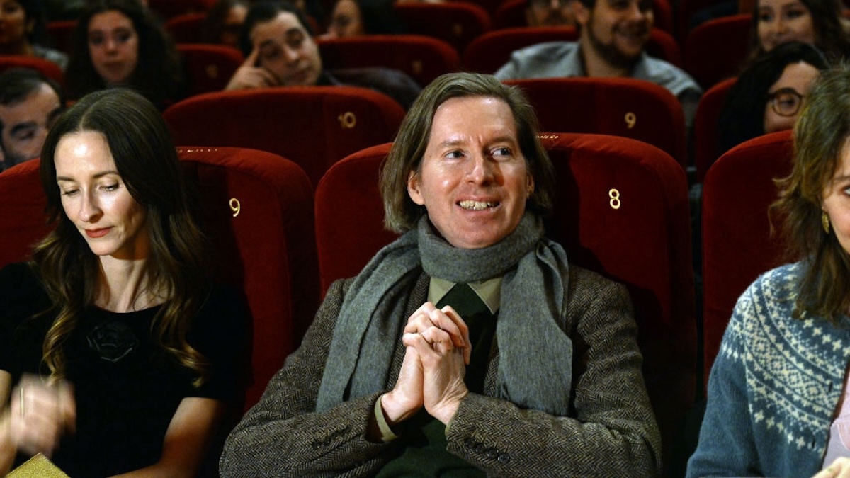 Wes Anderson sits in a movie theater.